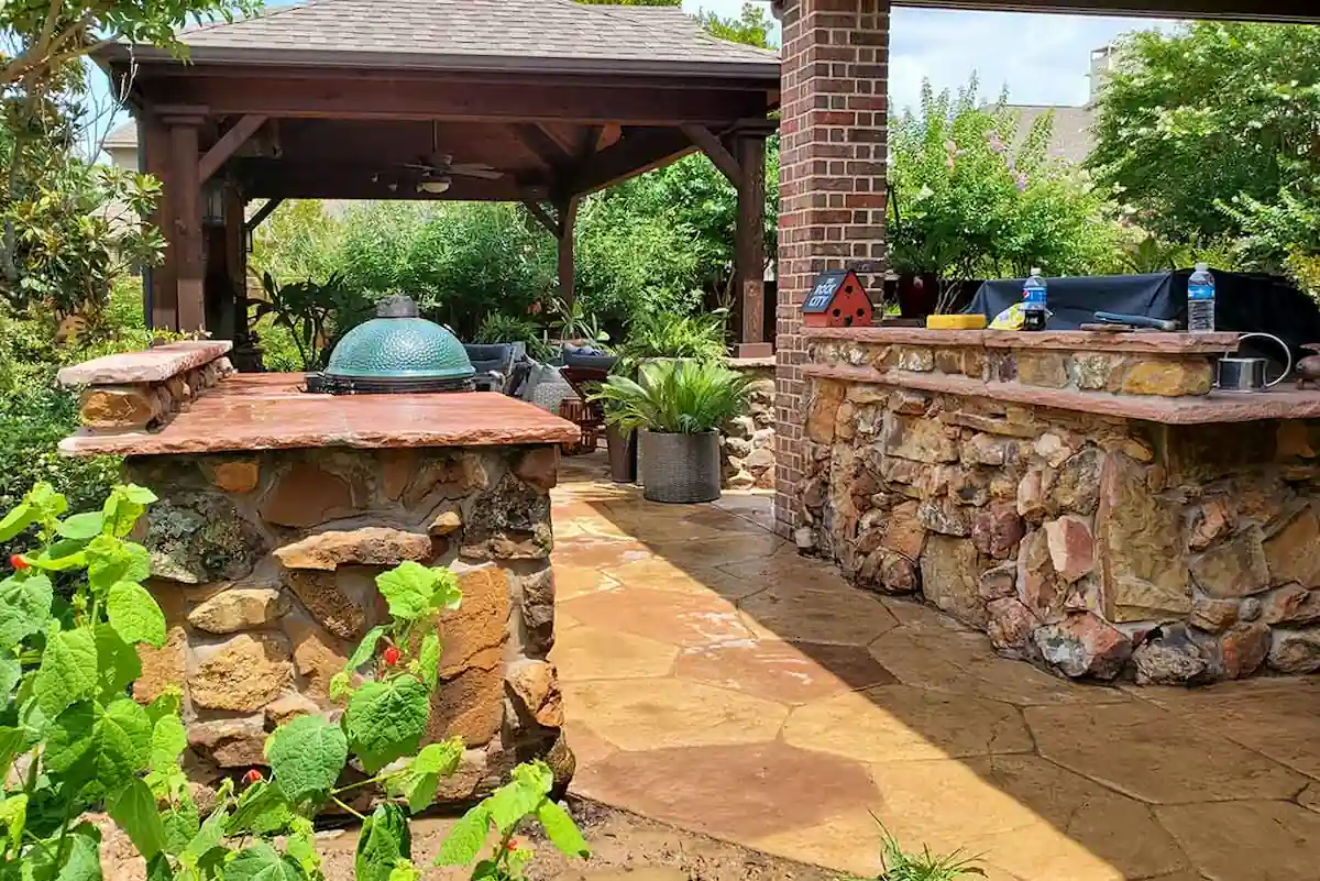Luxury outdoor living project with stone kitchen pavilion and firepit